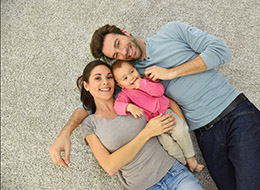 family laying on a clean carpet together